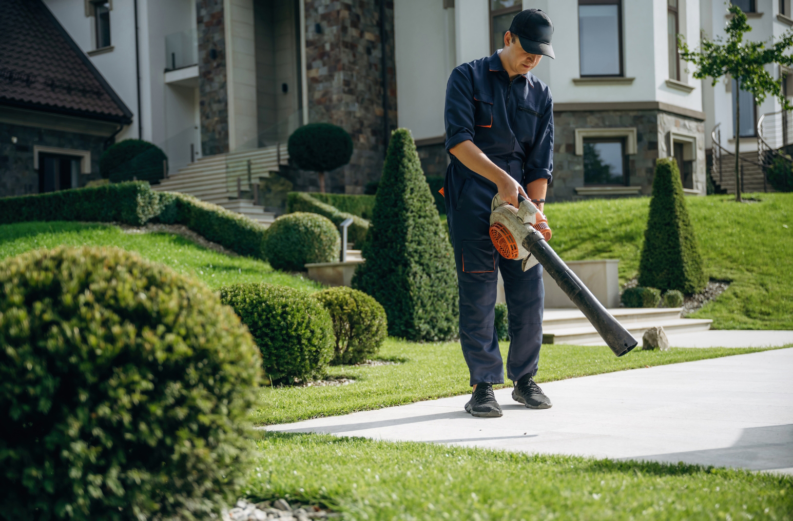 Blowing clippings off a sidewalk