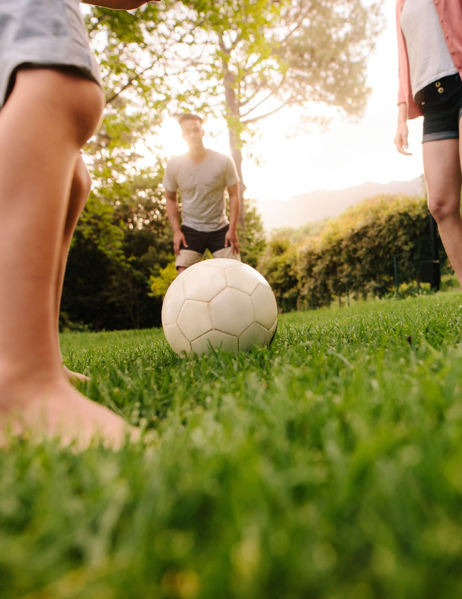 Family playing on a lush, well-maintained lawn
